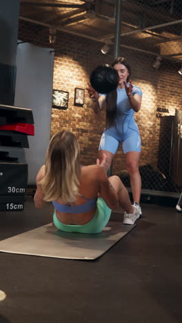 girls perform synchronized training routines with weights in gym, vertical