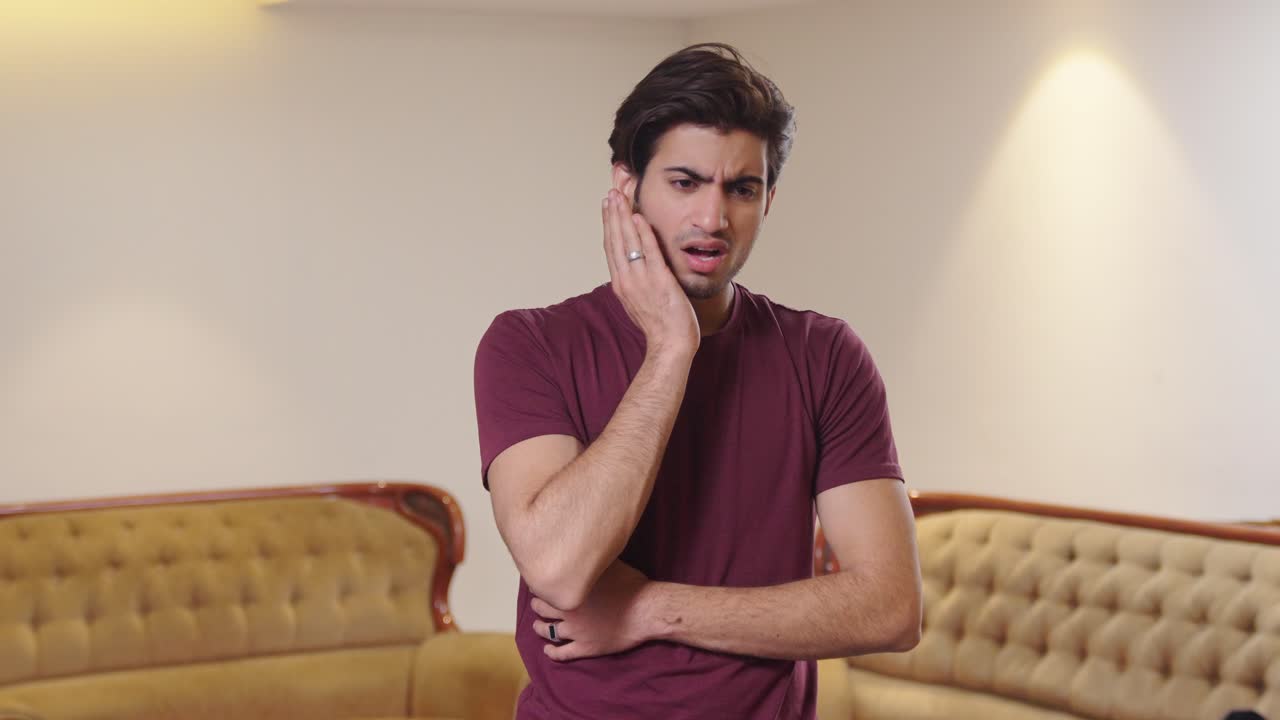 Indian man having a toothache
