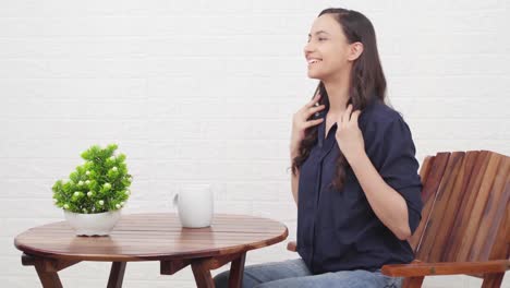 indian girl getting ready for someone at a cafe