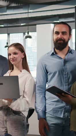 vertical video team of programmers in office automating repetitive tasks using ai scripts