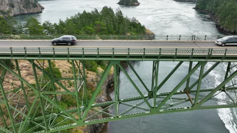 Medium-scrolling-drone-shot-of-people-commuting-across-Deception-Pass-bridge