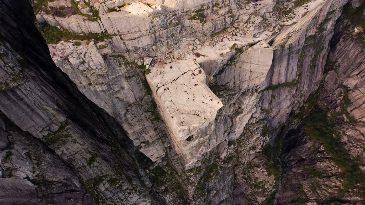 Stunning aerial of Lysefjord and Preikestolen plateau with visitors enjoying summer weather in Norway.