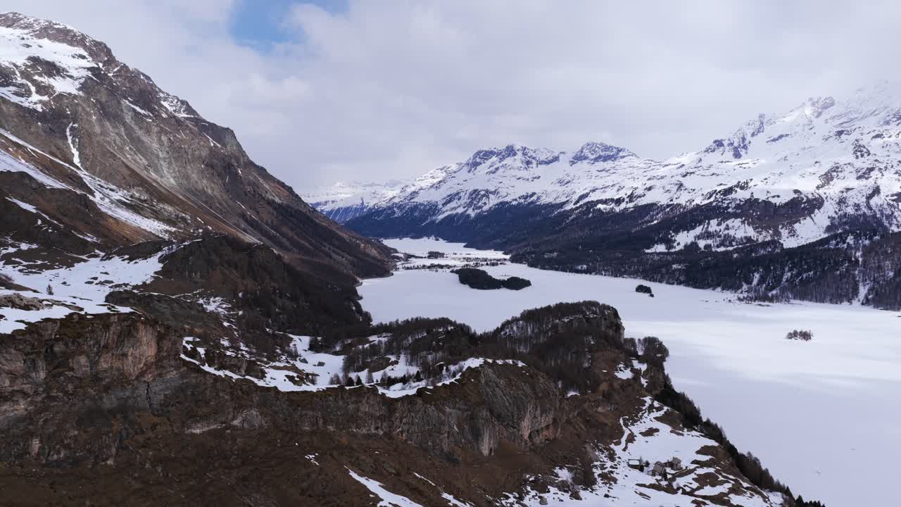 Rugged winter terrain of mountains and snowy valley, Malojapass, Switzerland