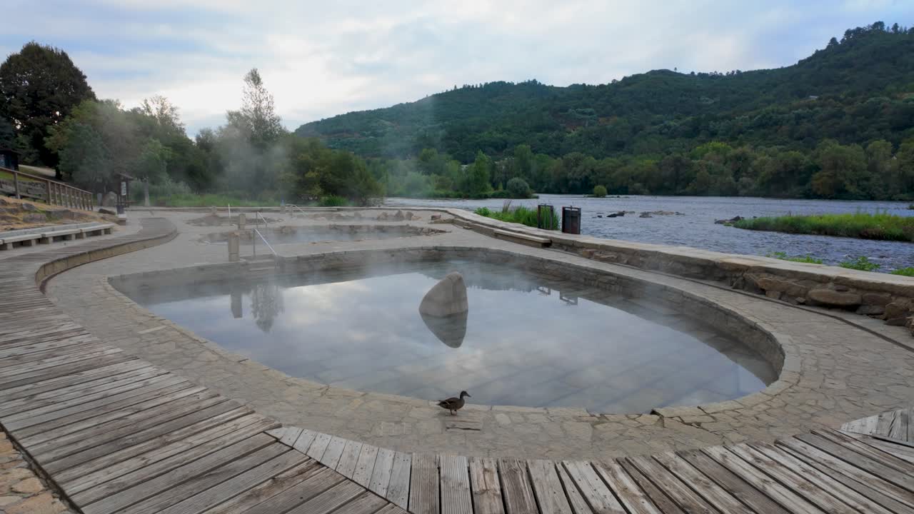 Establishing shot of Muiño da Veiga thermal baths in Ourense, Galicia, Spain