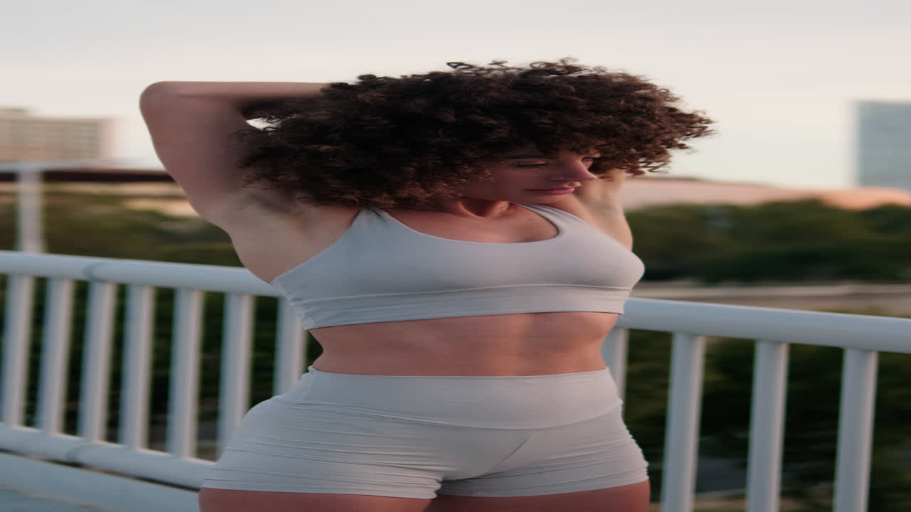 Woman Stretching on City Bridge