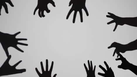ominous silhouettes of reaching hands