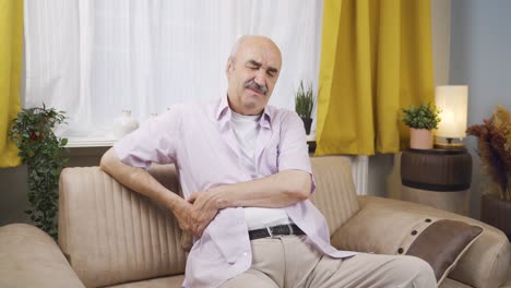 un anciano con dolor de espalda y hernia.
