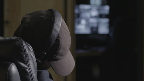 Security-guard-in-baseball-cap-falls-asleep-during-shift