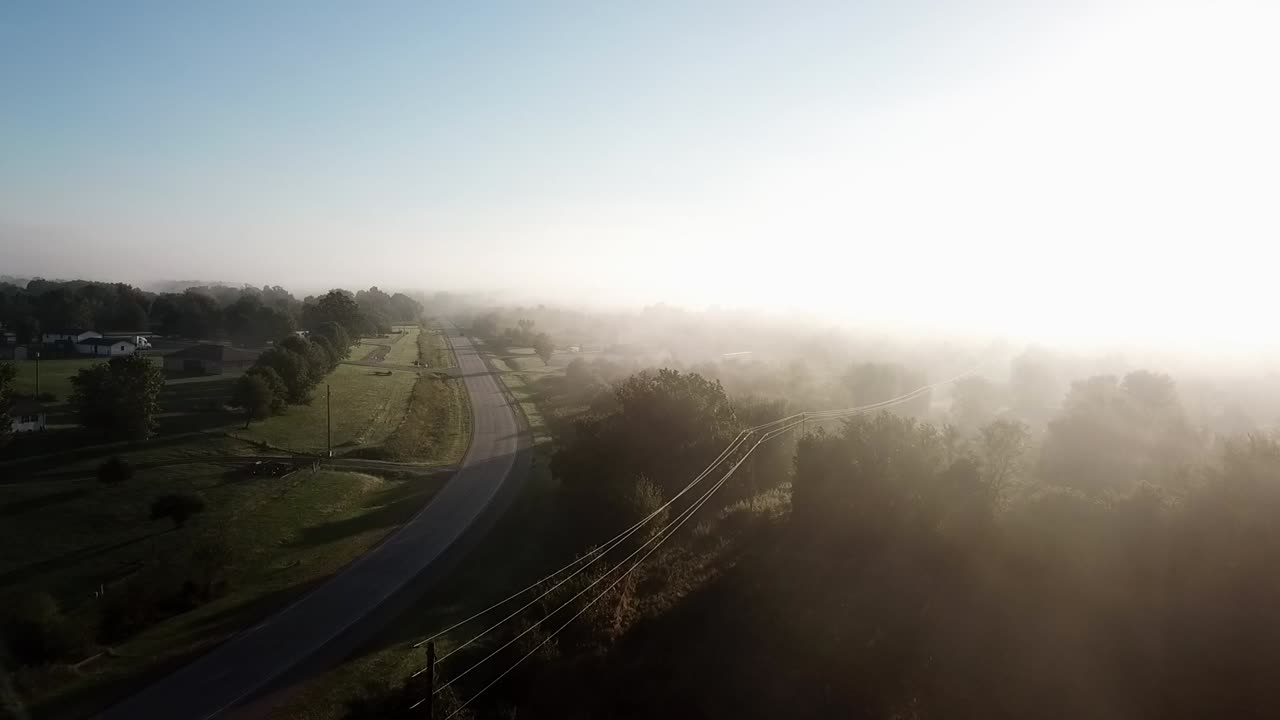 Flying through the fog near a rural highway in the Missouri Ozarks.