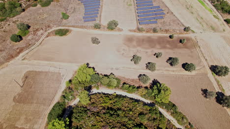 aerial view of agricultural land with solar panels in rural setting