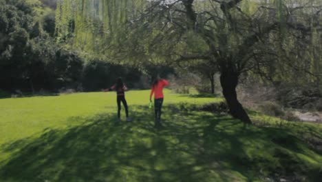 Chicas-Corriendo-En-Un-Bonito-Jardín-Natural