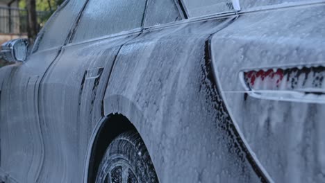 Car-With-Soap-Suds-In-Car-Wash-Garage---Close-Up