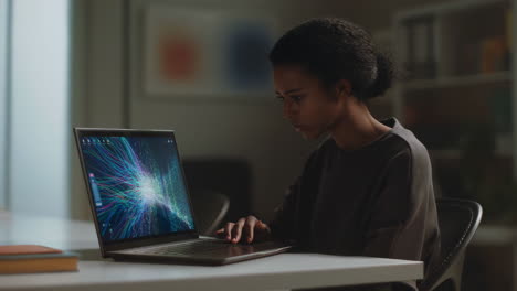 young person engaged with abstract graphics on a laptop