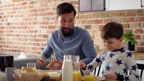 Handheld-video-of-father-and-son-eating-breakfast-together