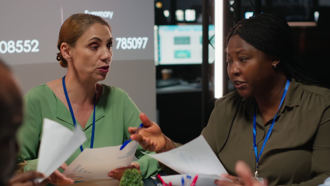 Close up of diverse business team meeting after hours for visual data reports