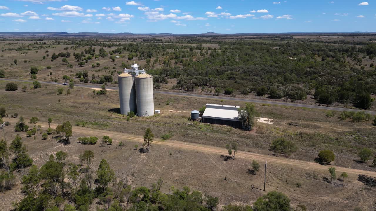 Right to left circular aerial views over grain silos just outside Wandoan, Queensland.