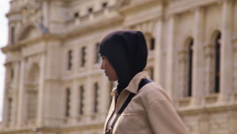 Muslim-Businesswoman-Wearing-Hijab-With-Modern-Business-Suit-Walking-To-Work-Past-City-Office-Buildings