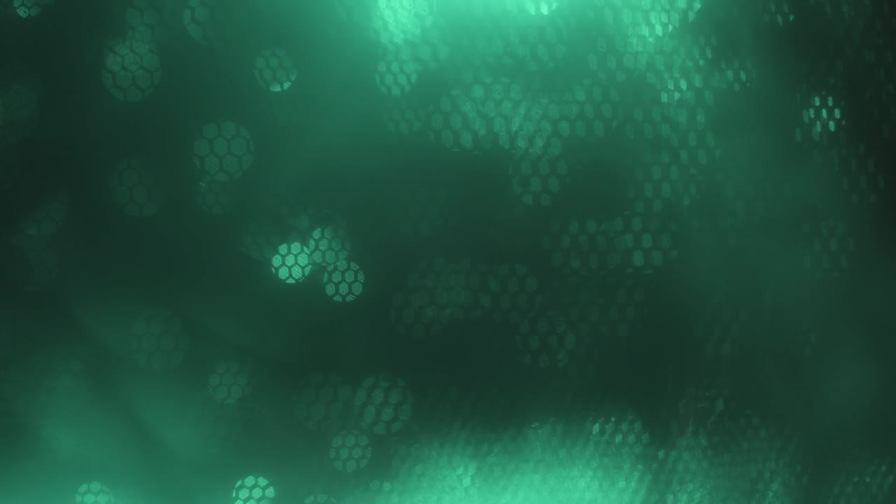 Turquoise abstract optical blurred background. Optical bokeh overlapped by moving honeycombs.