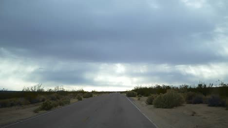 driving down desolate desert highway - slow motion