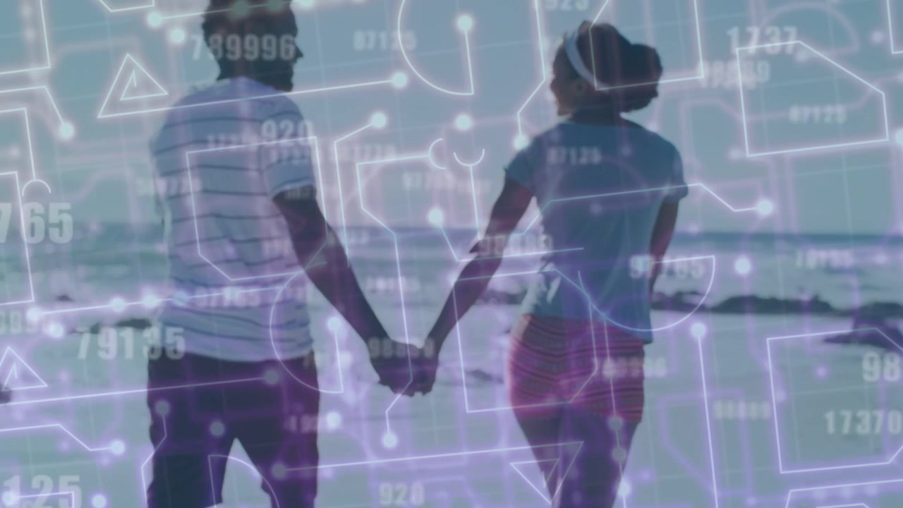 Couple holding hands on shoreline toward horizon, pullback revealing digital tech overlaying