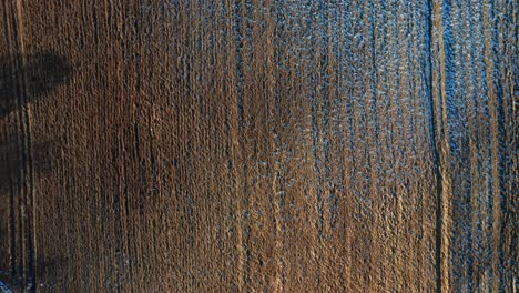 aerial: ploughed ground covered with frost in early spring