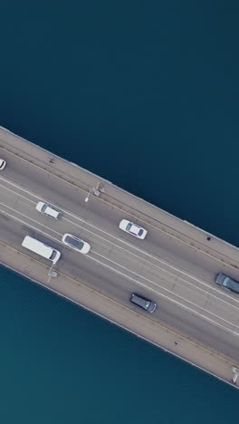 the bridge over the river. car traffic on the bridge. view from the top. aerial view. vertical video