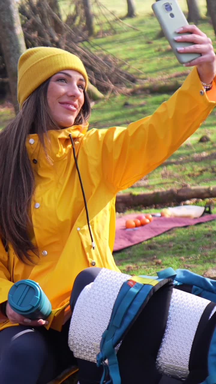 Woman taking a selfie in the forest