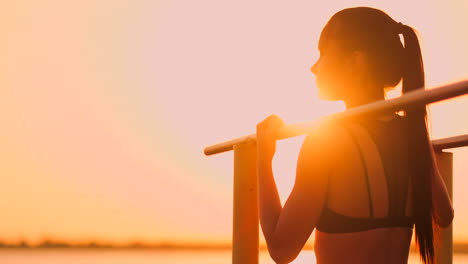 The-theme-women-sports-and-health.-Beautiful-caucasian-woman-with-curly-long-hair-posing-on-outdoor-sports-ground-holding-hor.-The-theme-woman-sports-and-health