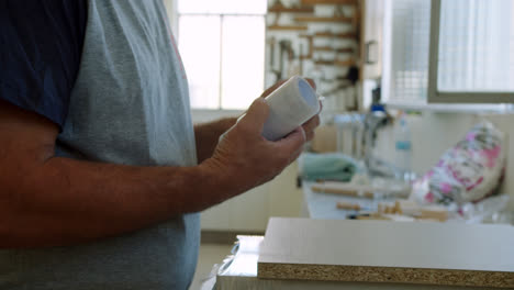 senior diy profesional hombre desenrollando envoltura de plástico para
