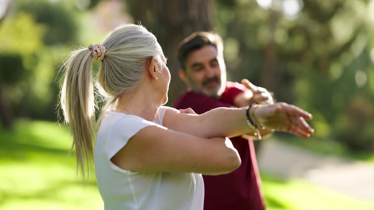Couple stretching in the park