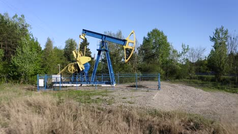 industrial old oil pump, remote countryside oil extraction