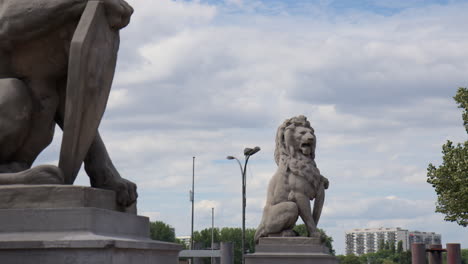 a stone lion sculpture positioned close to the scheldt river in antwerp, belgium - medium shot