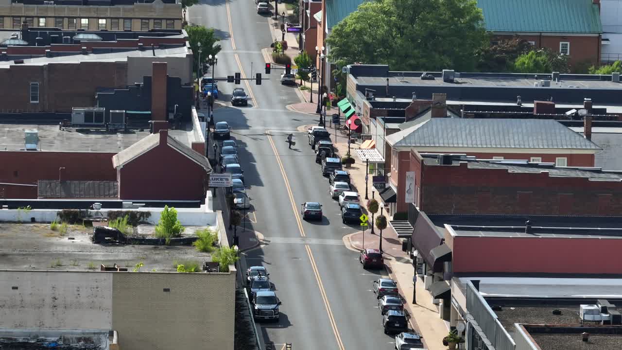 Main Street of America town ln with red brick building and pedestrian crossing road. Sunny summer day in Waynesboro, Virginia. drone wide shot