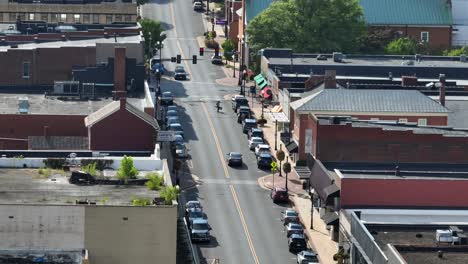 main street of america town ln with red brick building and pedestrian crossing road. sunny summer day in waynesboro, virginia. drone wide shot