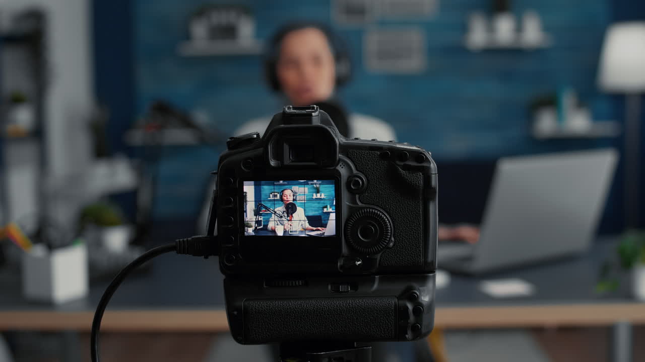 Professional modern camera recording internet star talking to audience