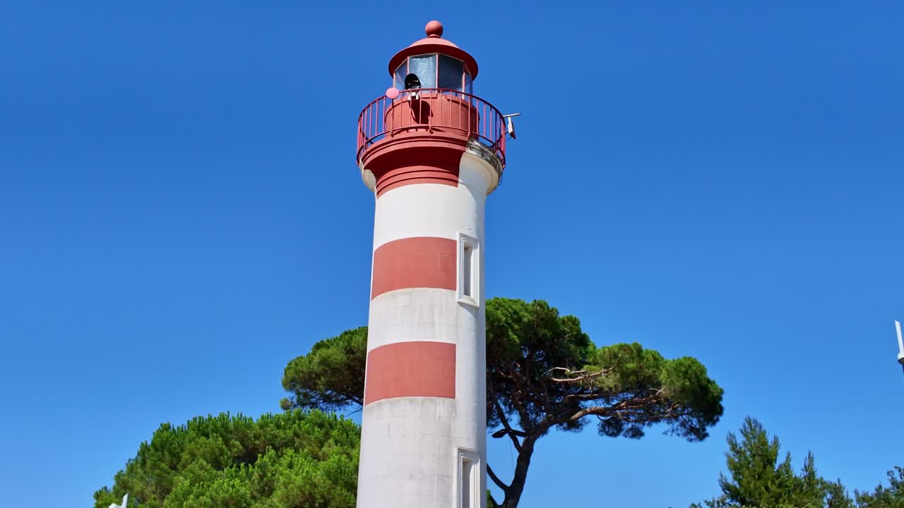 Endpoint view of red and white striped Old harbour lighthouse of La Rochelle, Charente-Maritime, France
