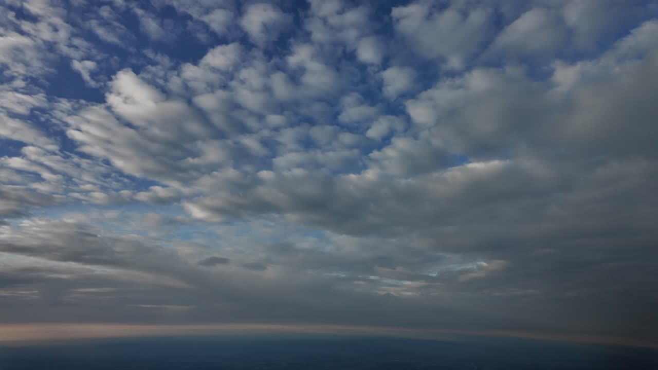 An immersive cockpit view flying through layers of ethereal clouds during climb. Aerial POV shot taken from a jet cockpit flying at supersonic speed. 4K