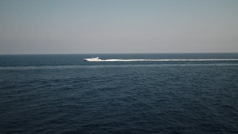 Vista-Aérea-De-Barco-De-Lujo,-Yate-De-Lujo-Moviéndose-Rápido-En-Aguas-Azules-Del-Océano-Horizonte-Marino