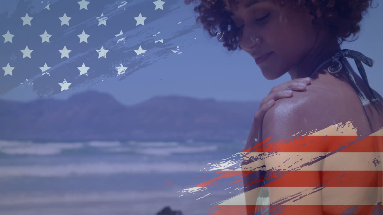 mujer en la playa con animación de bandera estadounidense sobre montañas y fondo oceánico