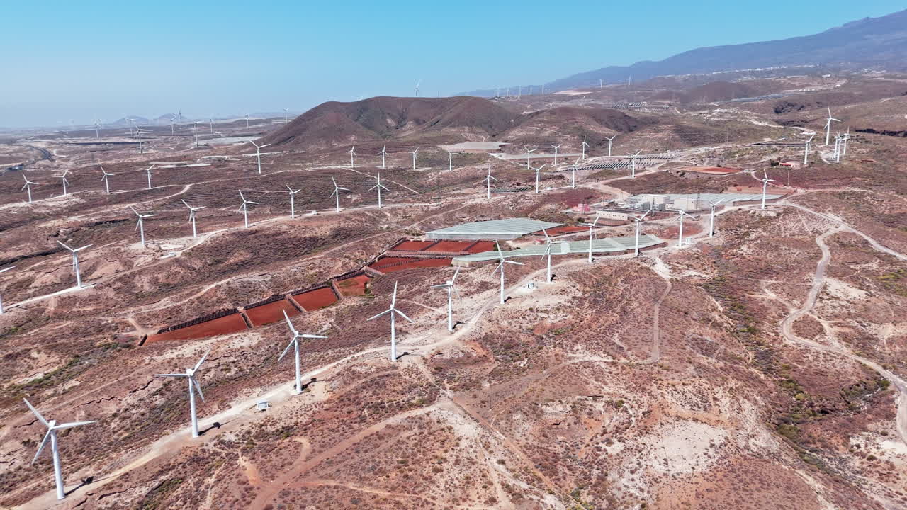Wind turbines in dry landscape of Tenerife under clear blue sky