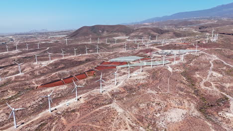 wind turbines in dry landscape of tenerife under clear blue sky