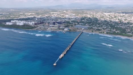 overview of industrial and city near the port of haina occidental during daytime in dominican republic