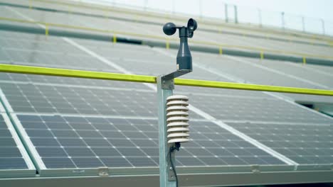 weather station for measuring wind velocity background solar cells. alternative source of electricity. solar farm.