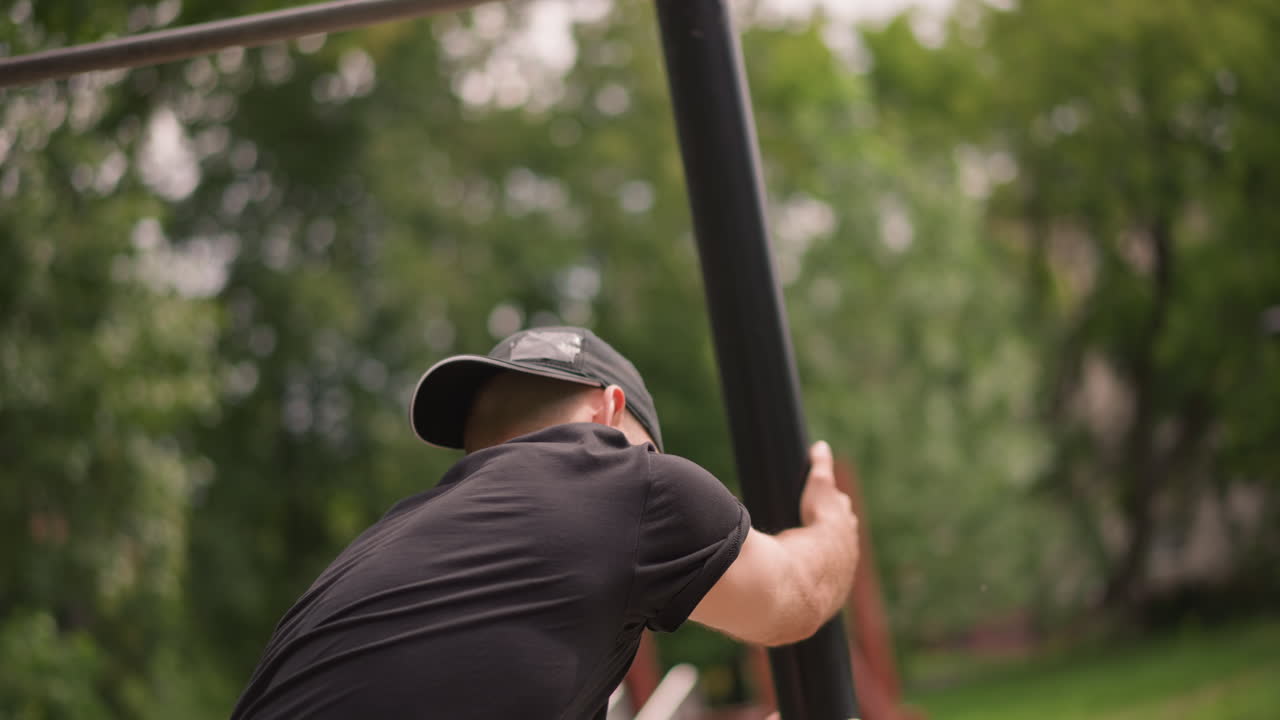 Worker Attaching Sturdy Metal Pole With Concentration, Male Technician Diligently Setting Up Metal Pole During Outdoor Work, Maintenance Worker Focused On Installing Metal Pole In Park Environment