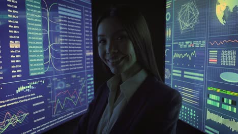 the businesswoman looks on a blue screen in the dark lab