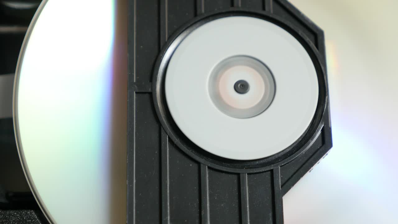 Compact disk reading mechanism slow tilt 4K 2160p UHD footage - Reading sequence of DVD disc in player 4K 3840X2160 UltraHD  video