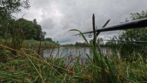 Timelapse-of-Fishing-Rods-in-the-Lake-Rainy-Cloudy-Summer-Day