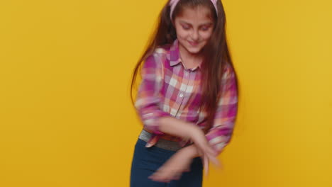 Trendy-cheerful-positive-happy-child-girl-kid-dancing-and-moving-to-rhythm-making-dub-dance-gesture