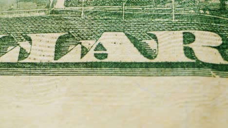 a closeup view of a fifty dollar bill on a polished wooden table, highlighting its intricate design