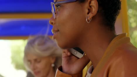 commuters talking on mobile phone while travelling in bus 4k